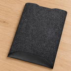 Ambientação AI baseada na fotografia do fornecedor: capa preta sobre uma secretária de carvalho claro